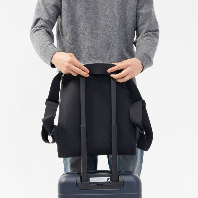Alex Large Backpack sleeve over a suitcase handle