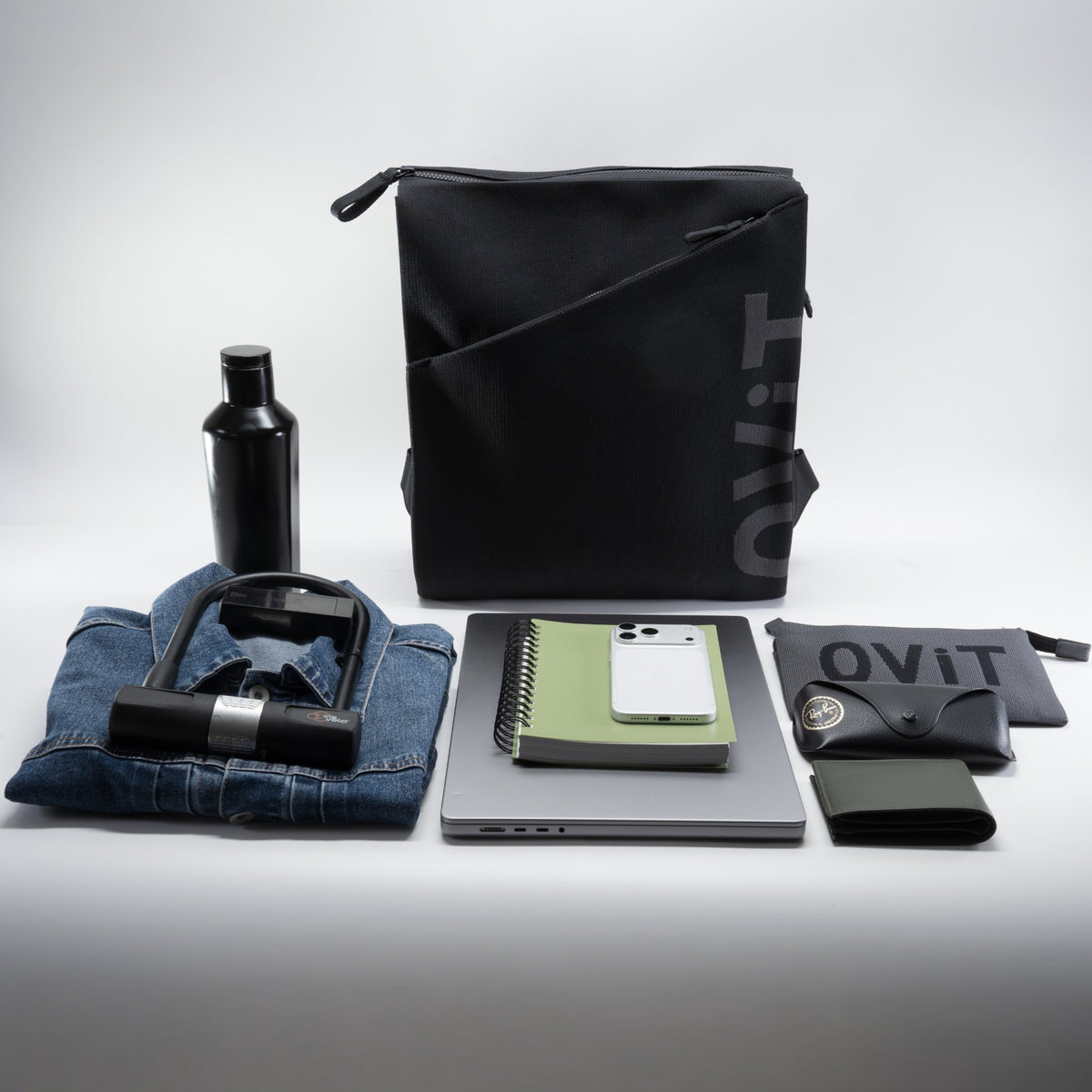 Alex Large Backpack with what fits: 16-inch MacBook, notebook, phone, water bottle, bike lock, denim jacket, pouch, glasses case, wallet